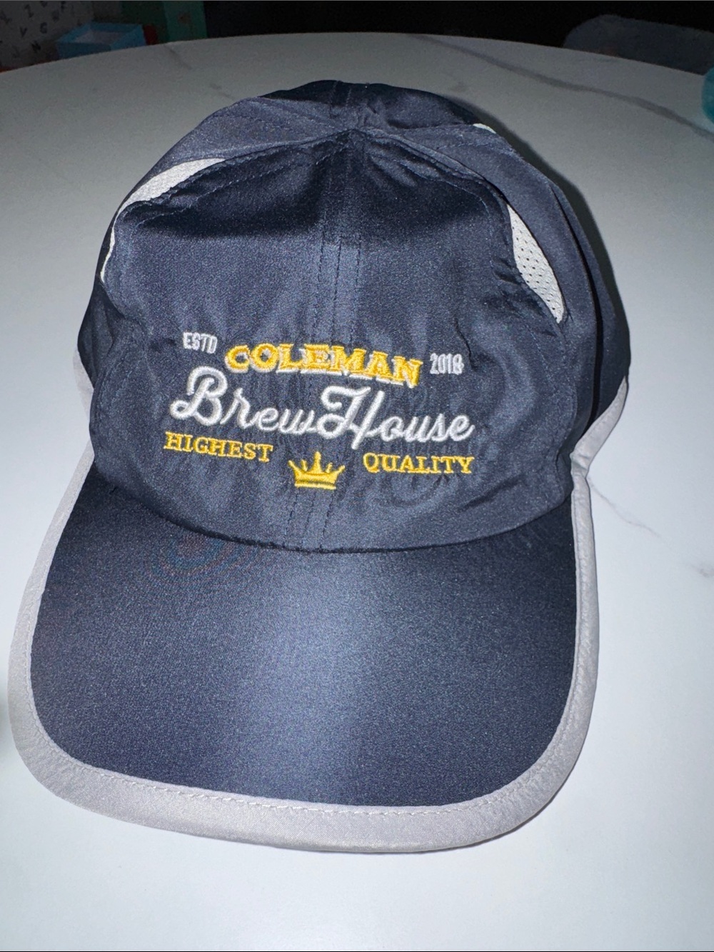 Coleman Brew House Navy Cap with Gray Trim and Yellow Embroidery